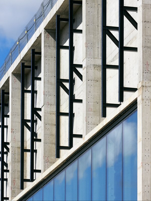 fragment of the facade, concrete, glazing, black steel structural elements