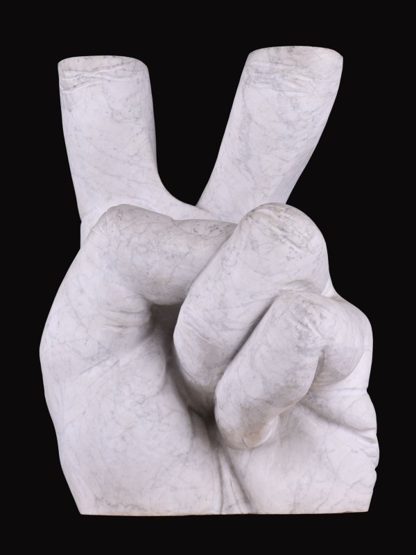 photo of the sculpture, hand in the V gesture