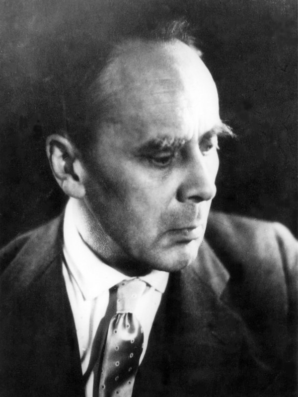 Zdjęcie przedstawia Tadeusza Manteuffla z profilu - mężczyznę o szczupłej twarzy, wysokim czole i krzaczastych brwiach.  Mężczyzna ma na sobie białą koszulę, krawat i marynarkę.