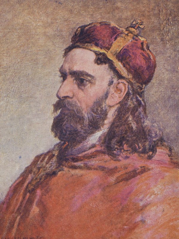 Ukazany z profilu dość młody mężczyzna z ciemną brodą, wąsami i długimi włosami. Na głowie ma czerwoną mitrę książęcą.  