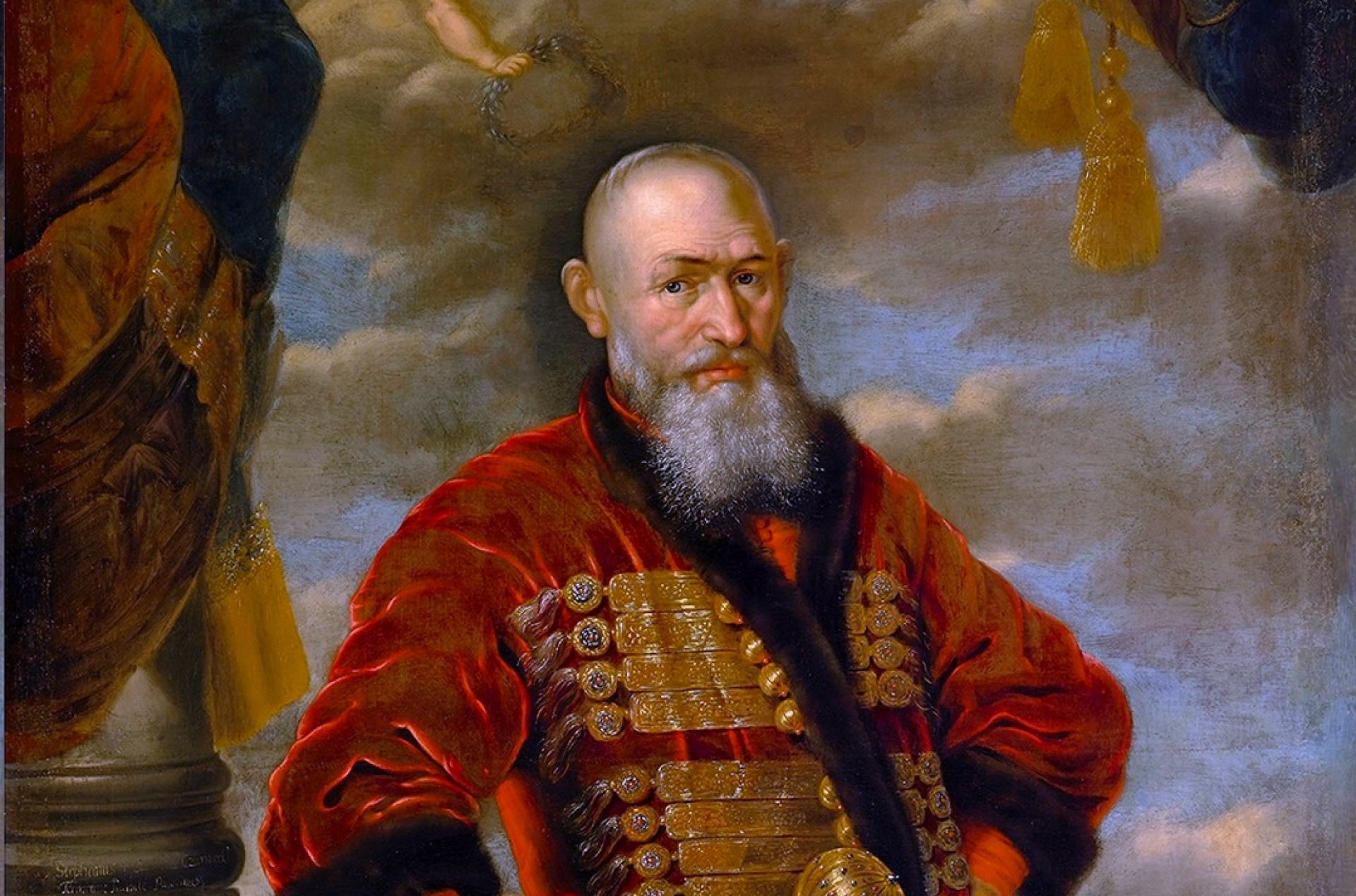 Mężczyzna z siwą brodą w czerwonym stroju szlacheckim, ze złota buławą w ręku.