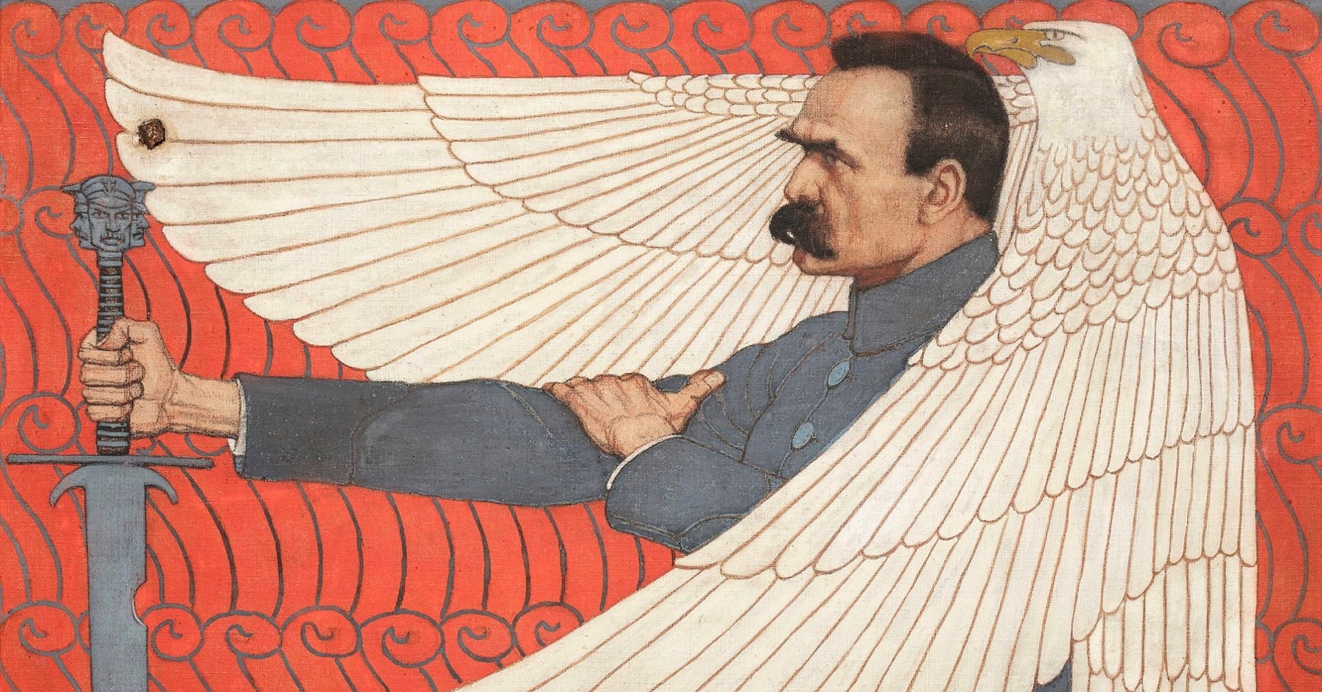 Obraz przedstawia Józefa Piłsudskiego w szarym mundurze, z prawą dłonią wspartą na mieczu. Marszałka osłania skrzydłami wielki biały orzeł.