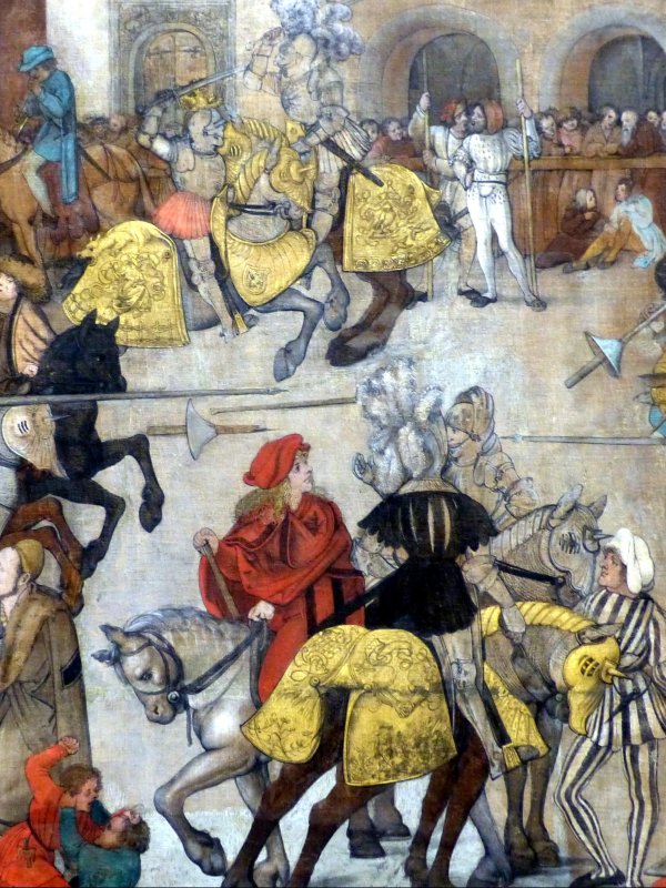 Rycerze w zbrojach na kolorowo przystrojonych koniach walczą w turnieju na dziedzńcu zamku.