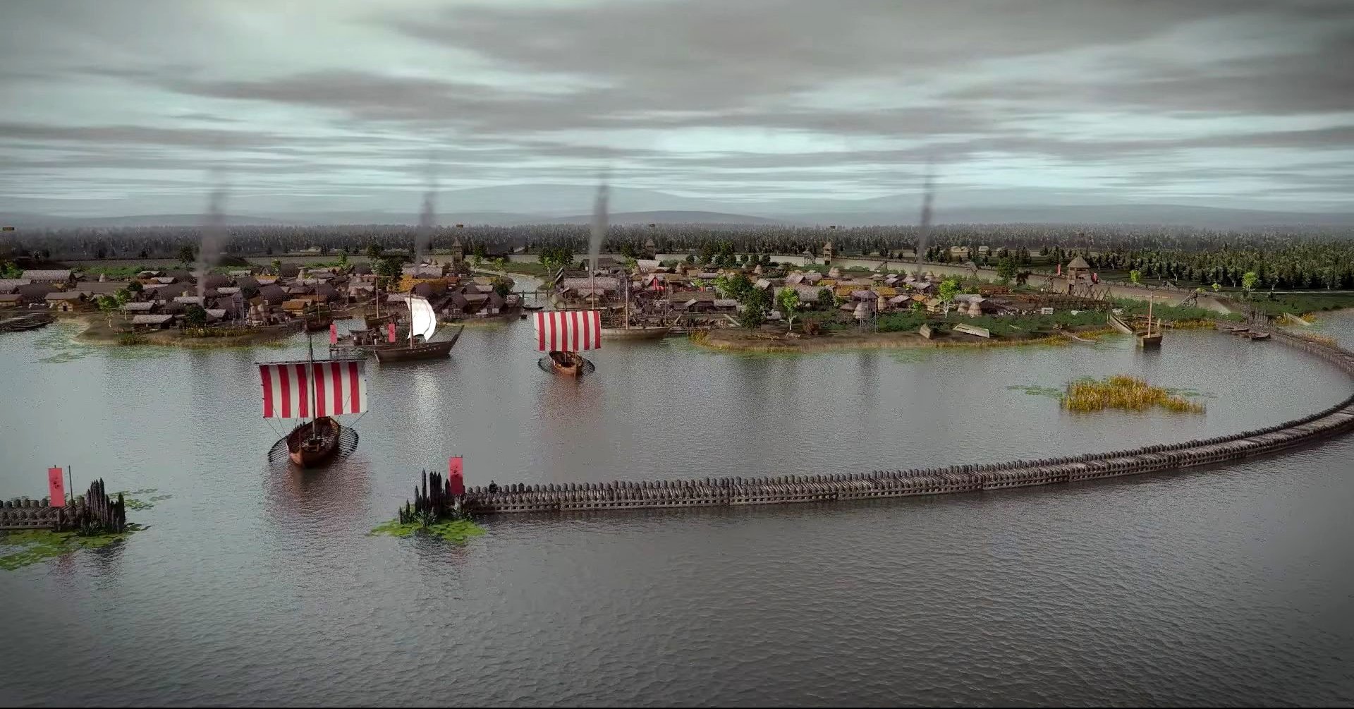 Zdjęcie przedstawia osadę na brzegu jeziora.  Część jezora otoczona jest drewnianym płotem. Na wodzie widać kilka łodzi z biało-czerwonymi żaglami. 